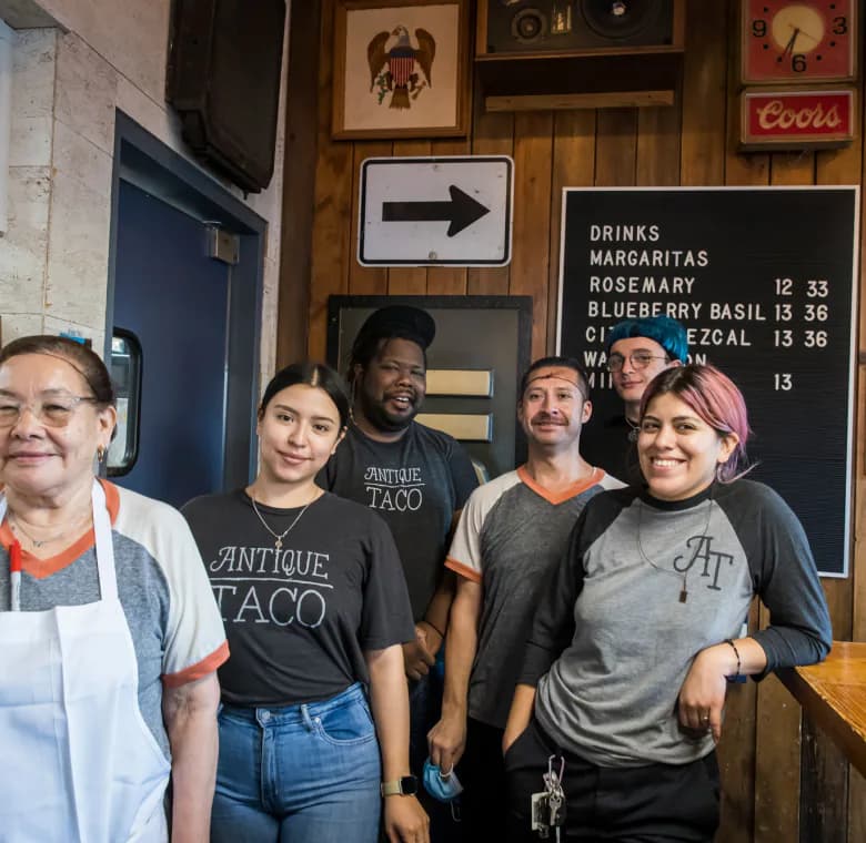 Antique Taco workers smiling and posing