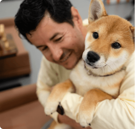Roberto Bustillos holding a Shiba Inu puppy