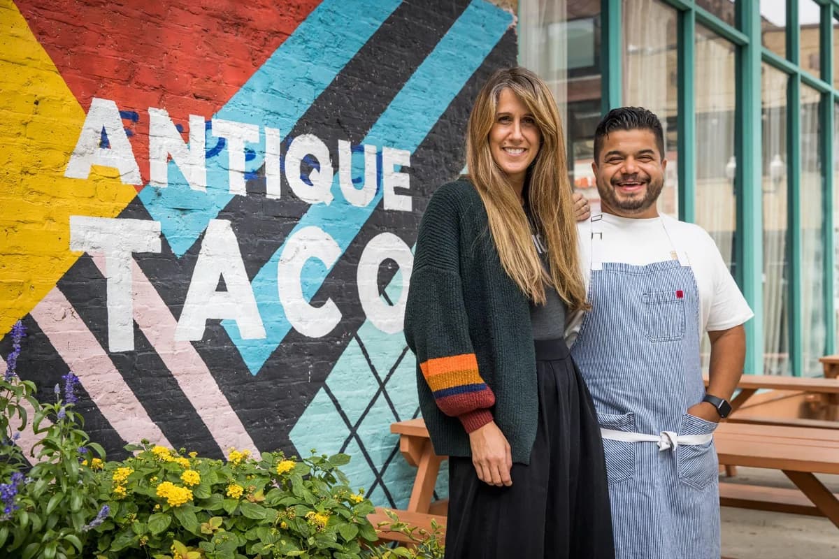 The owners of Antique Taco standing outside their restaurant