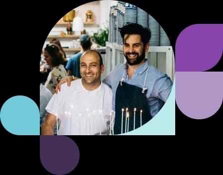 Two men posing in a restaurant