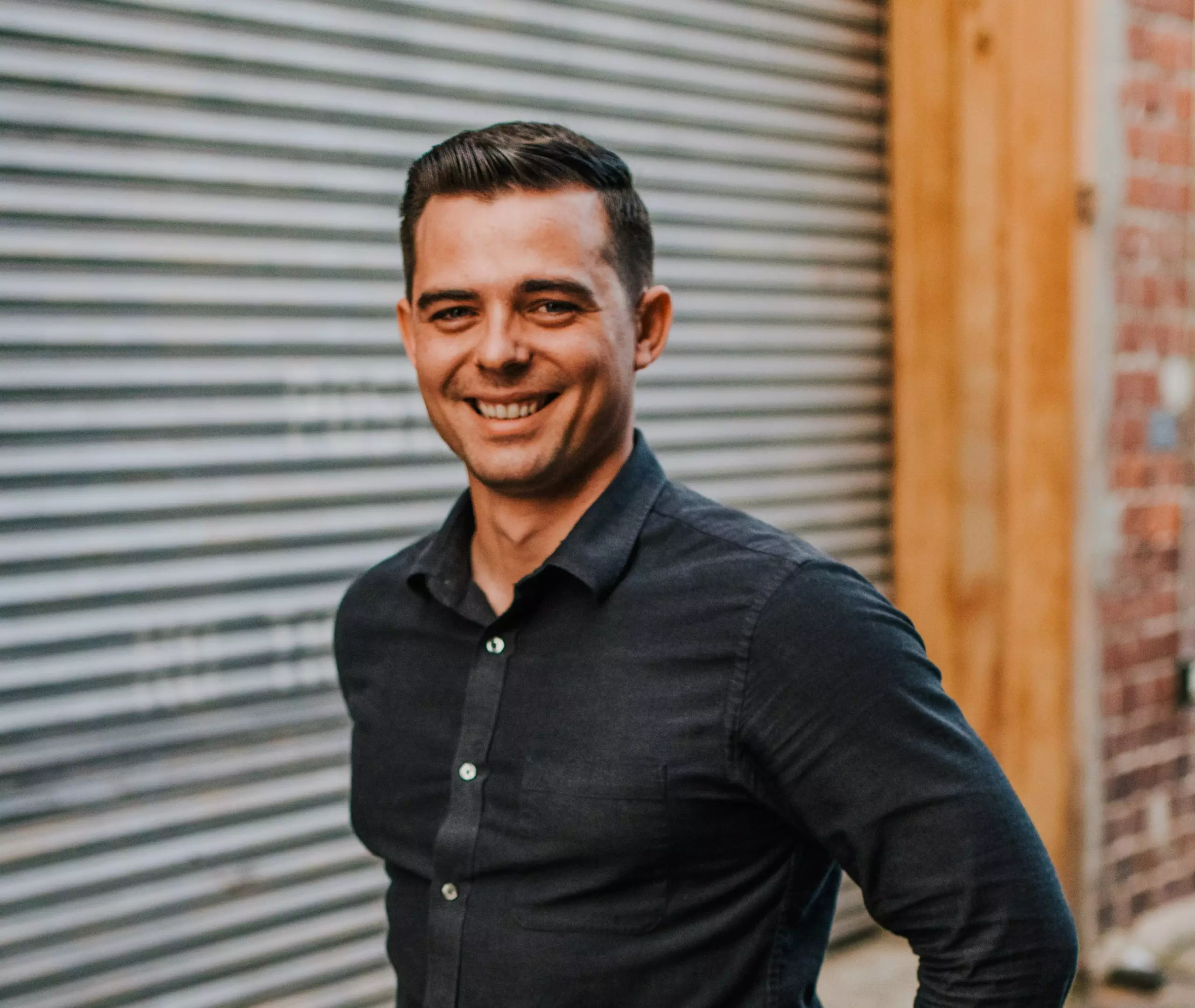 Man smiling in dark button up